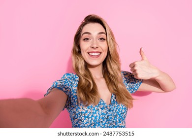 Photo of attractive young woman take selfie photo thumb up dressed stylish blue flower print clothes isolated on pink color background - Powered by Shutterstock