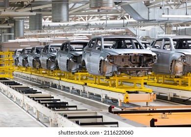 Photo of automobile production line. Modern car assembly plant. Modern and high-tech automotive industry. Conveyor of auto bodies - Shutterstock ID 2116220060