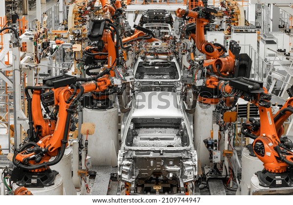 Photo of automobile\
production line. Modern car assembly plant. Modern and high-tech\
automotive industry