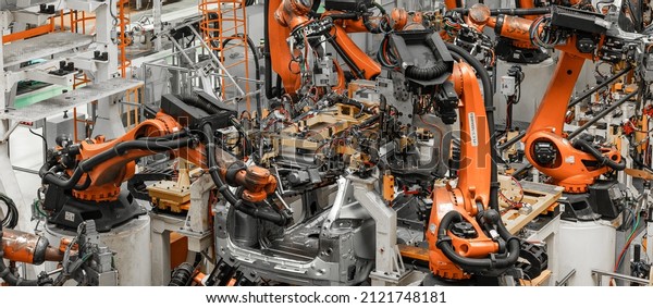 Photo of automobile\
production line. Modern car assembly plant. Modern and high-tech\
automotive industry