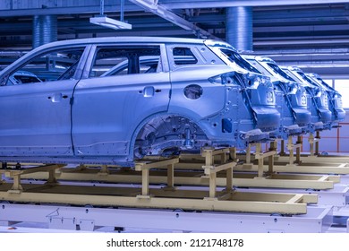 Photo Of Automobile Production Line. Welding Car Body. Modern Car Assembly Plant. Auto Industry. High-tech Factory. Blue Tone