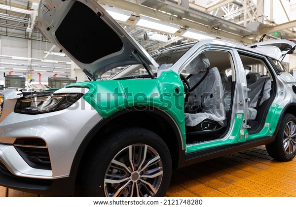 Photo of automobile\
production line. Welding car bodies. Modern car assembly plant.\
Auto industry