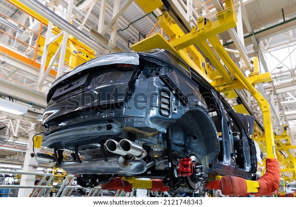 Photo of automobile production line. Welding car\
body. Modern car assembly plant. Auto industry. Interior of a\
high-tech factory