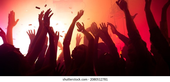 Photo of bachelors clubbers guys ladies silhouettes enjoy electro star private occasion raise hands up on red bright disco