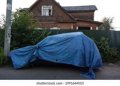 Photo Of A Background With A Car Covered With A Polypropylene Blanket