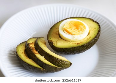 A photo of a baked avocado with a hard-boiled egg - Powered by Shutterstock