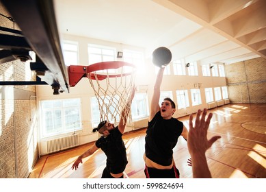 Photo of basketball players playing basketball on the court. - Powered by Shutterstock