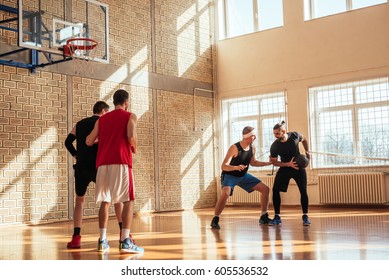 Photo of basketball teammates playing indoors. - Powered by Shutterstock