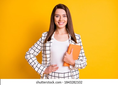 Photo Of Beaming Cute Adorable Teacher Woman Arm Waist Holding Closed Book Isolated Yellow Color Background