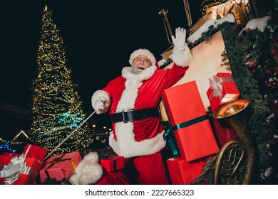 Photo of bearded old big cartoon personage stand decorated sleigh waving hand ho-ho-ho ready flight moonlight star sky miracle outdoors - Powered by Shutterstock