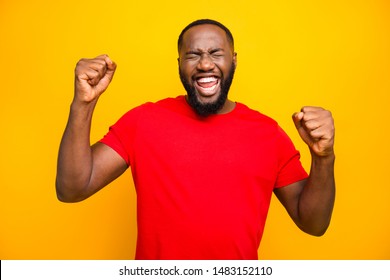 Photo of bearded overjoyed ecstatic man having won some competitions while isolated with yellow background