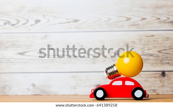 photo of beautiful bulb and car shaped toy on\
the wonderful white studio\
background