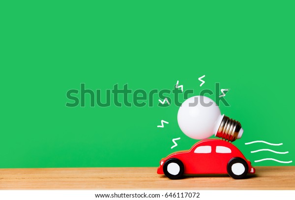 photo of beautiful bulb and car shaped toy on\
the wonderful green studio\
background