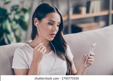 Photo Of Beautiful Business Lady Hold Telephone Use Earphones Chatting Web Cam Talk Colleagues Reliable Worker Quarantine Social Distancing Stay Home Sit Cozy Couch Living Room Indoors