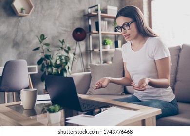 Photo Of Beautiful Business Lady Stay Home Quarantine Talk Skype Online Interview Good Mood Asking Job Candidate Vacancy Question Gesturing Hands Friendly Hr Sit Sofa Living Room Indoors