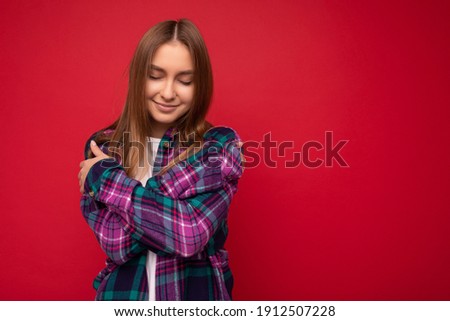 Similar – Image, Stock Photo young blonde pretty woman with orange sweater and scarf is standing at the railing outside and looks thoughtfully into the distance