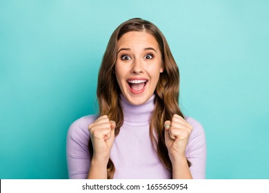 Photo of beautiful funny lady hold hands fists raised yelling loud supporting favorite sports team competition wear purple jumper isolated teal blue pastel color background