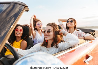 Photo of a beautiful gorgeous smiling cheery young pretty women friends driving the car. - Powered by Shutterstock