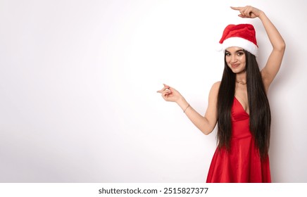 Photo of beautiful lady good mood direct fingers side empty space presenting novelty newyear sale prices banner poster wear red snow girl dress santa cap isolated white background - Powered by Shutterstock