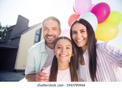 Photo Of Beautiful Positive Family Of Three People Take Selfie Toothy Smile Colorful Balloons Outdoors