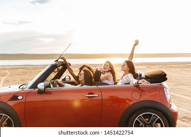 Photo of a beautiful pretty happy smiling cheery young pretty women friends driving the car raised up hands. - Powered by Shutterstock