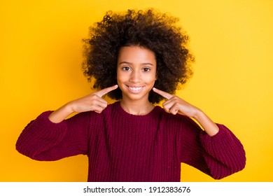 Photo of beautiful wavy hairdo dark skin schoolgirl indicate fingers toothy smile isolated on yellow color background