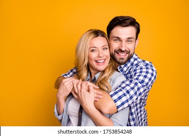 Photo beautiful wife lady handsome husband guy couple hugging good mood in love perfect pair hold arms wear casual shirts clothes isolated yellow color background - Powered by Shutterstock