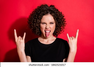 Photo Of Beautiful Young Girl Tongue Out Hands Show Rock Gesture Isolated On Vivid Red Color Background