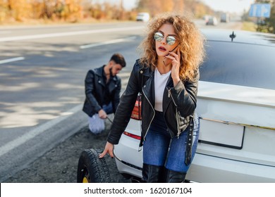 Photo Of Beautiful Young Woman Using Her Mobile Phone Calls For Assistance For Car.