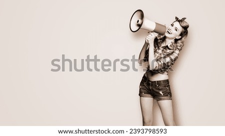 Photo of beauty woman holding mega phone megaphone shout advertising. Girl in pin up style wear. Beauty model retro fashion concept. Brown toned black and white bw photo. Monochrome image copy space.