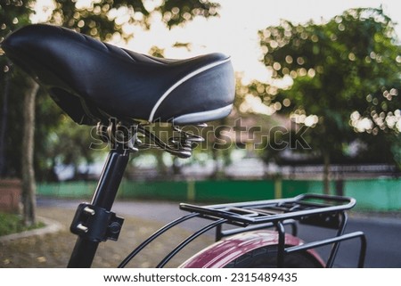 photo of a bicycle saddle in a close up against the background of sunlight