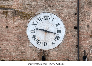 A photo of a big clock on a facade pointing on 09:20 - Powered by Shutterstock