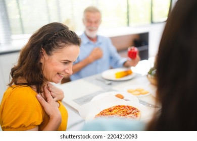 Photo Of Big Family At Home, People Sit Feast Dishes Table Around Roasted Turkey Multi-generation Relatives Making Group With Food And Pizza In House Living Room Indoors