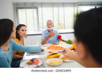 Photo Of Big Family At Home, People Sit Feast Dishes Table Around Roasted Turkey Multi-generation Relatives Making Group With Food And Pizza In House Living Room Indoors