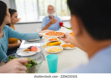 Photo Of Big Family At Home, People Sit Feast Dishes Table Around Roasted Turkey Multi-generation Relatives Making Group With Food And Pizza In House Living Room Indoors