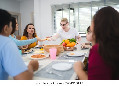 Photo Of Big Family At Home, People Sit Feast Dishes Table Around Roasted Turkey Multi-generation Relatives Making Group With Food And Pizza In House Living Room Indoors