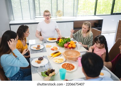 Photo Of Big Family At Home, People Sit Feast Dishes Table Around Roasted Turkey Multi-generation Relatives Making Group With Food And Pizza In House Living Room Indoors