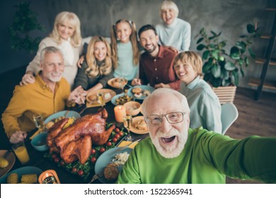 Photo Of Big Family Sit Hugging Feast Dishes Table Around Roasted Turkey Multi-generation Relatives Grey-haired Grandpa Making Group Selfies In Living Room Indoors