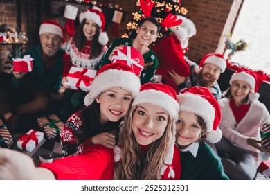 Photo of big full friendly family take selfie hold presents gathering celebrate christmas apartment indoors - Powered by Shutterstock