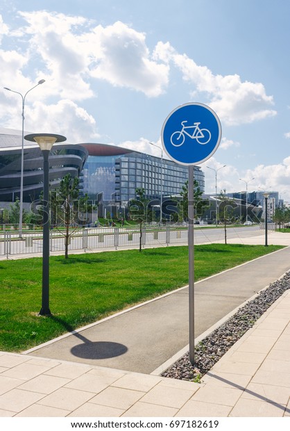 Photo of the bike path and road sign of the bike\
path in the city