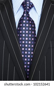 Photo Of A Black Pinstripe Suit With Blue Striped Shirt And Purple And Blue Patterned Tie