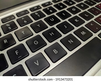 photo of a black qwerty keyboard on a silver background
