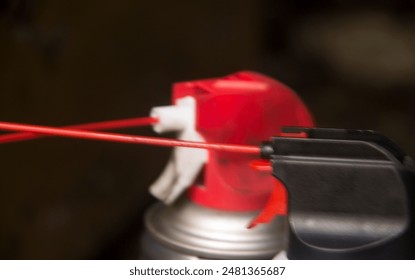 photo of a black and red spray bottle head with a red straw - Powered by Shutterstock