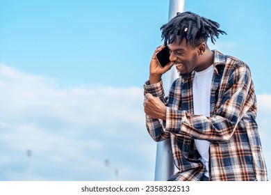 photo of black young man using smartphoe for calling - Powered by Shutterstock