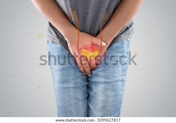 The photo of the bladder is on the\
man\'s body against a gray background. People want to pee and is\
holding his bladder. Urinary incontinence\
concept