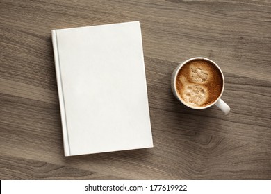 Photo blank book cover on textured wood background with cape of coffee