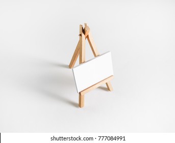 Photo Of Blank Business Card On Wood Holder At White Paper Background.