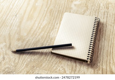 Photo of blank sketchbook with a pencil on light wooden background with soft shadows. Template for graphic designers portfolios. - Powered by Shutterstock