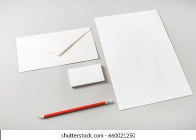 Photo Of Blank Stationery Set On Paper Background. Letterhead, Business Cards, Envelope And Pencil. Template For Placing Your Design. Top View.