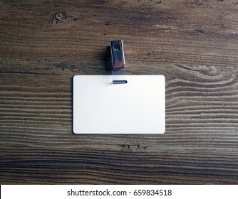 Photo Of Blank White Plastic Badge On Vintage Wooden Table Background. Blank Id Card. Top View.